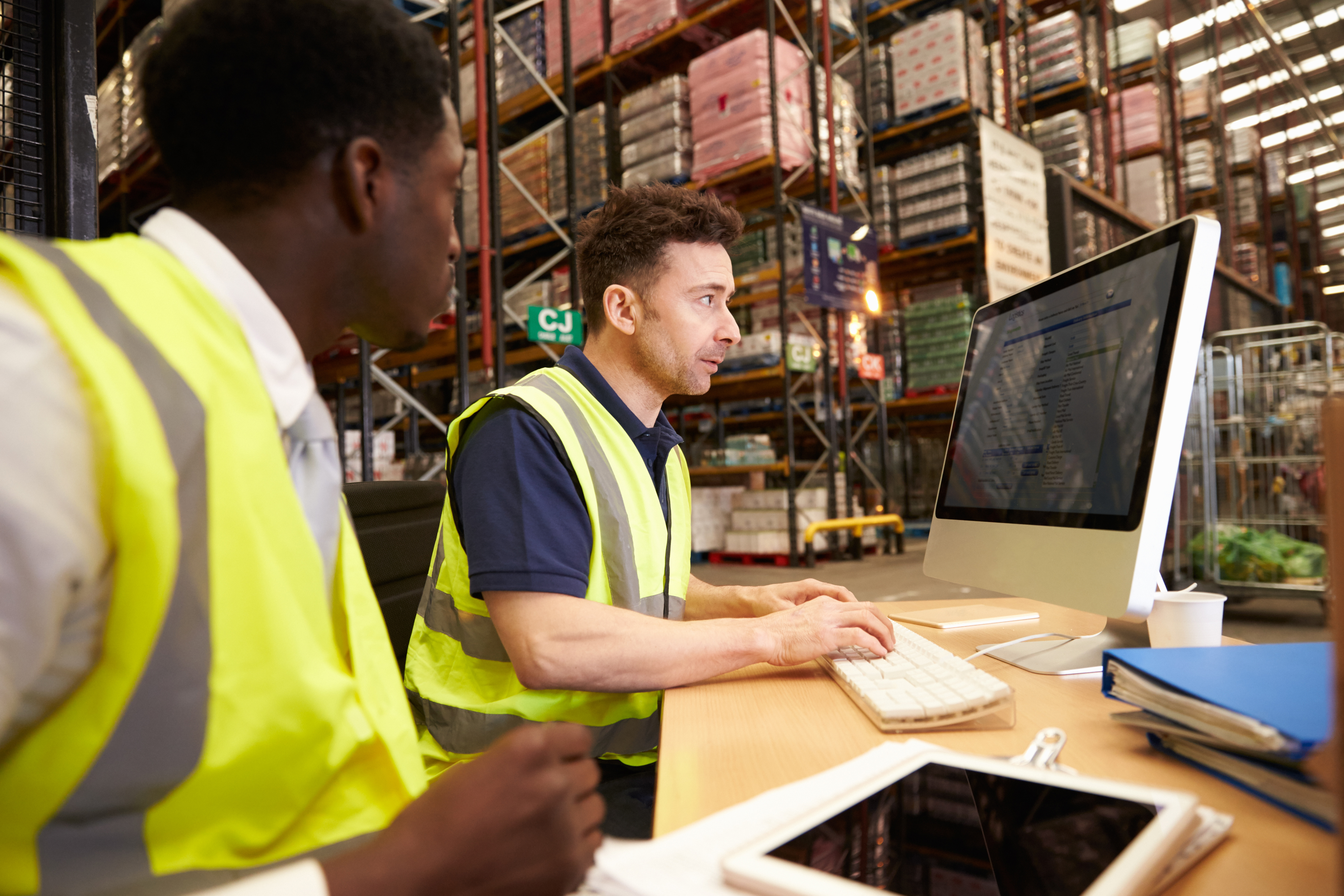 a man in a vest looking at a computer