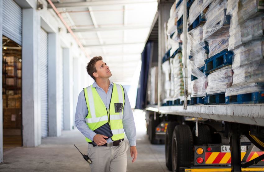 Man walking past pallets