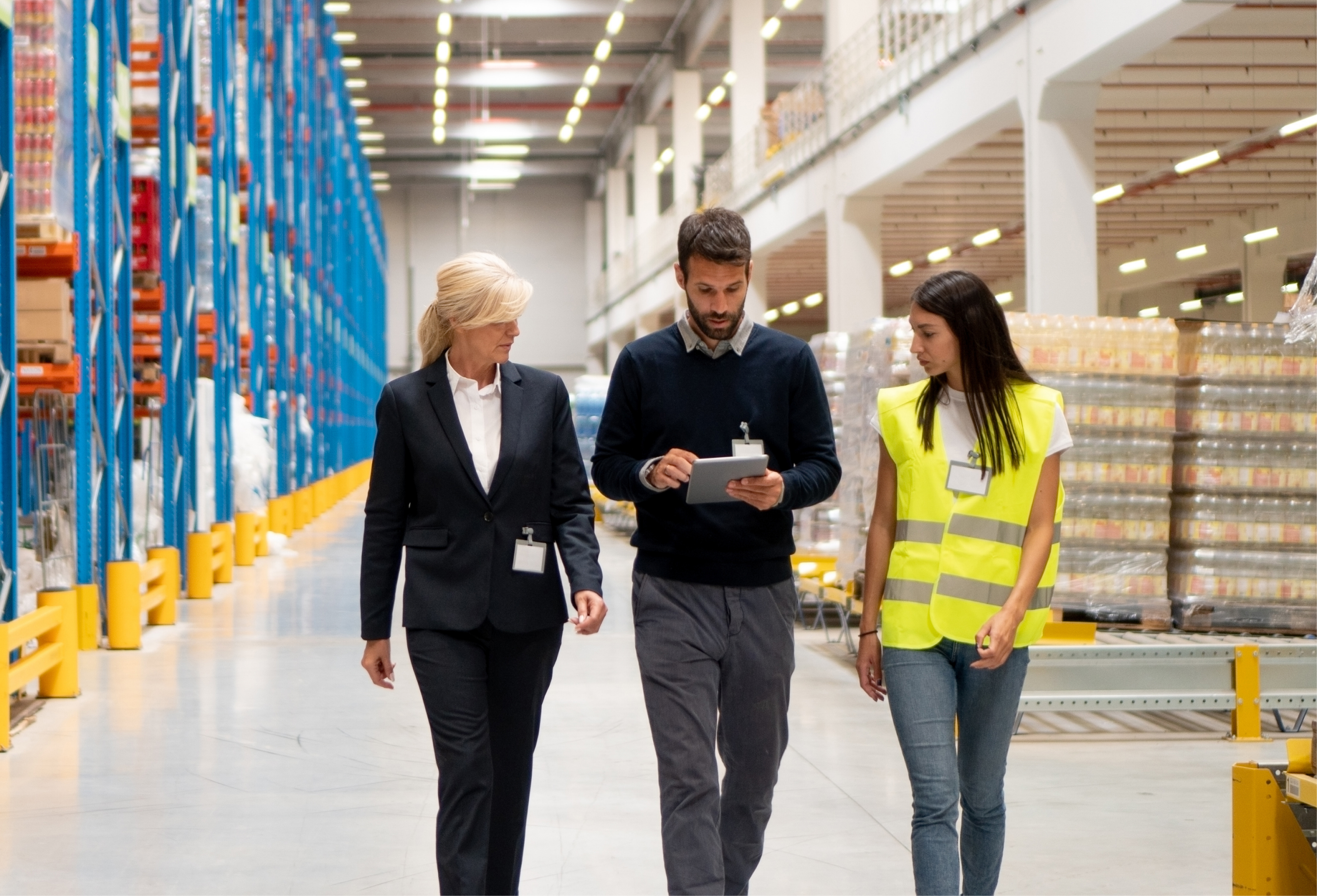 a group of people walking in a warehouse