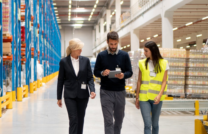 a group of people walking in a warehouse