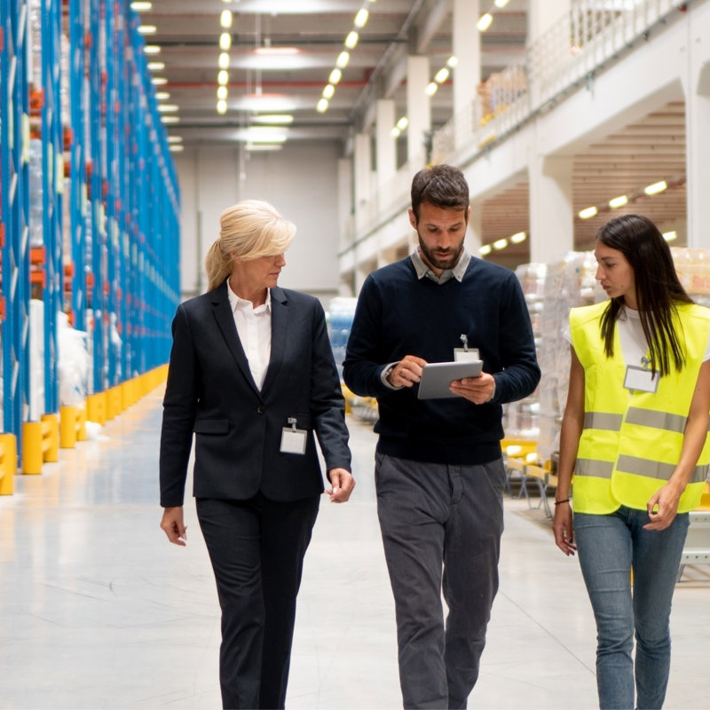 a group of people walking in a warehouse