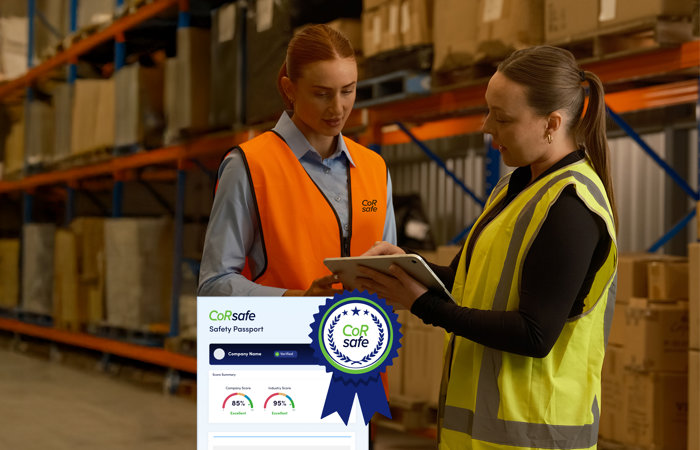 a woman in safety vests looking at a tablet