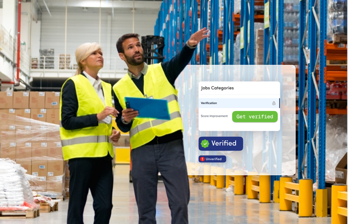 a man and woman in safety vests in a warehouse