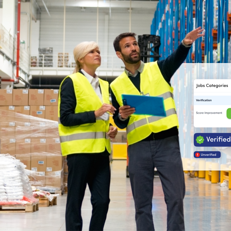 a man and woman in safety vests in a warehouse